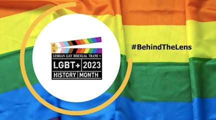 image shows the behind the lens campaign logo with the pride flag in the background