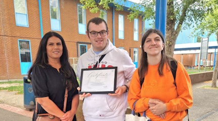 Image shows Community Connector Anita with Mathew and Lisa proudly showing off their Hounslow Community Award Certificate