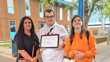 Image shows Community Connector Anita with Mathew and Lisa proudly showing off their Hounslow Community Award Certificate