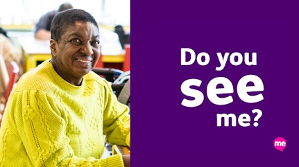 Image shows a picture of faye smiling wearing a yellow jumper next to purple campaign graphic representing learning disability week with the words 'Now you see me' written in white text and the Mencap logo