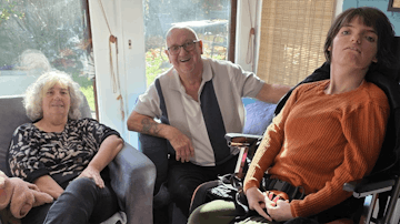 Image shows family smiling at the camera