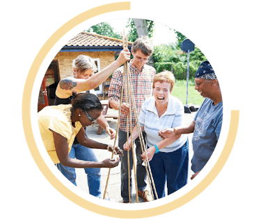 image shows people working together to make something in the garden