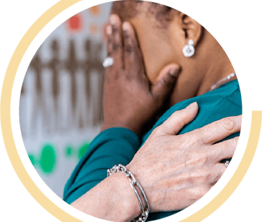 image shows a woman being comforted